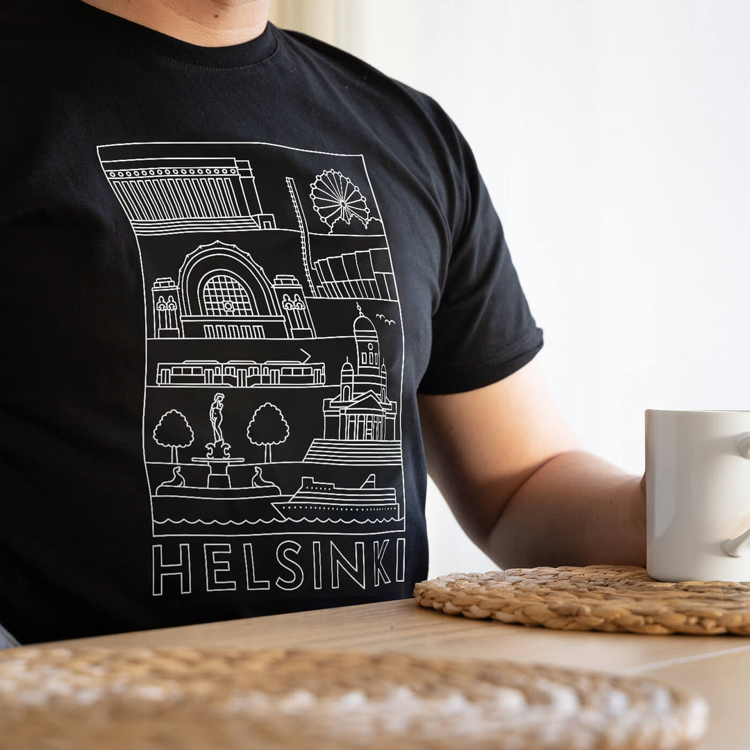 Musta kaupunkipaita päällä, rinnassa Helsingin kohteet ja kaupungin nimi valkoisena